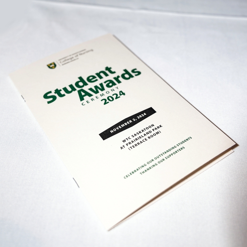 Student awards ceremony itinerary, laying on a white tablecloth