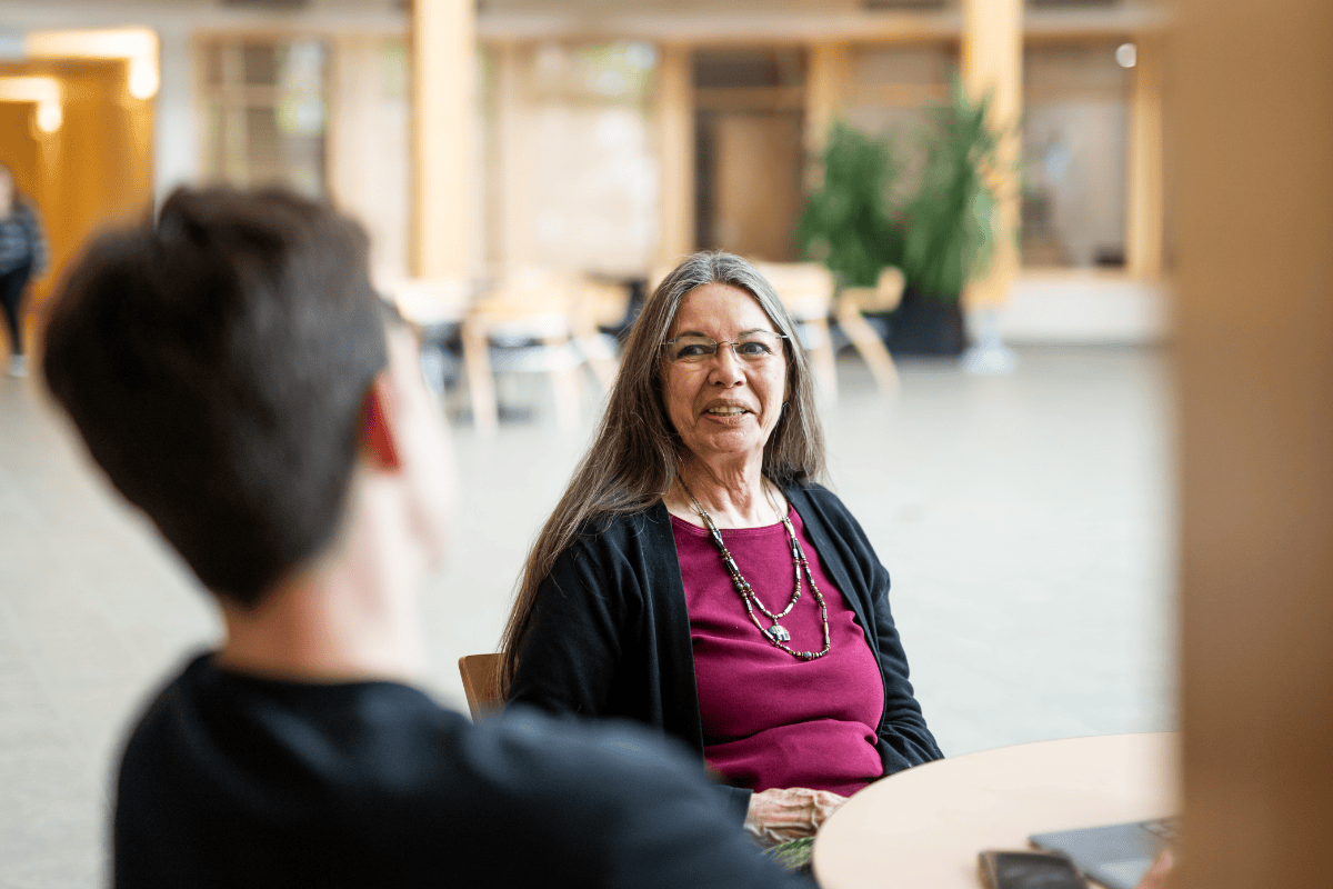 Kathleen McMullin talking with a student