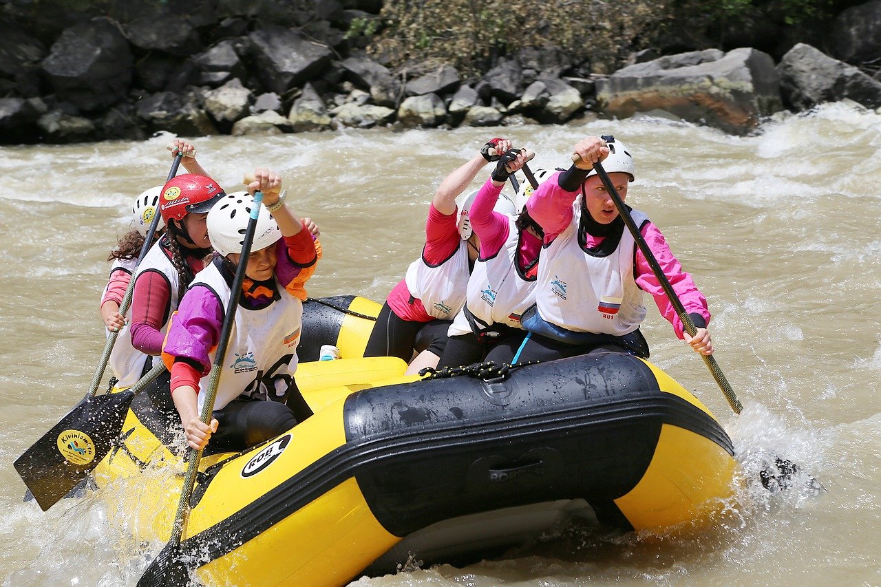 Six people paddling a raft