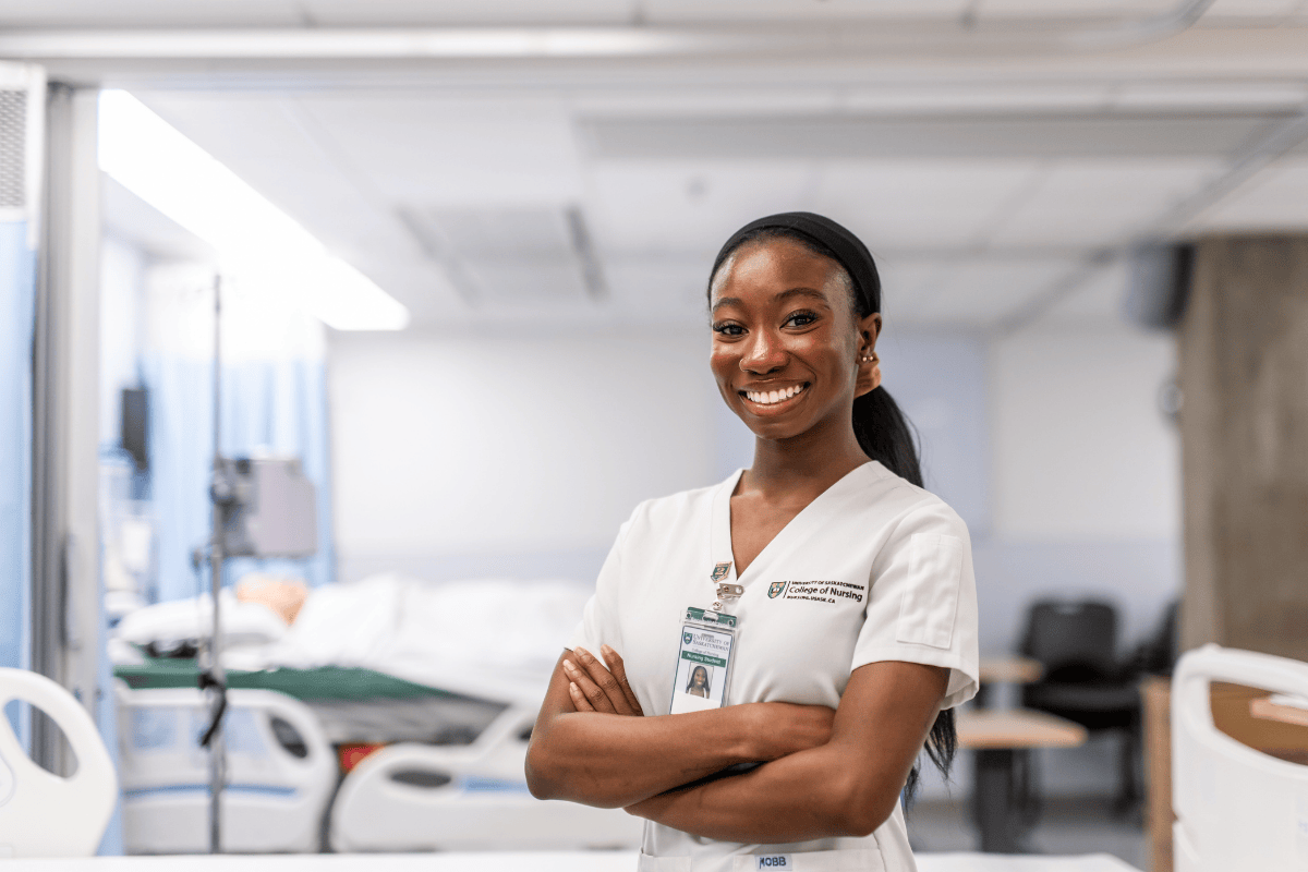 female nursing student in white scrubs 